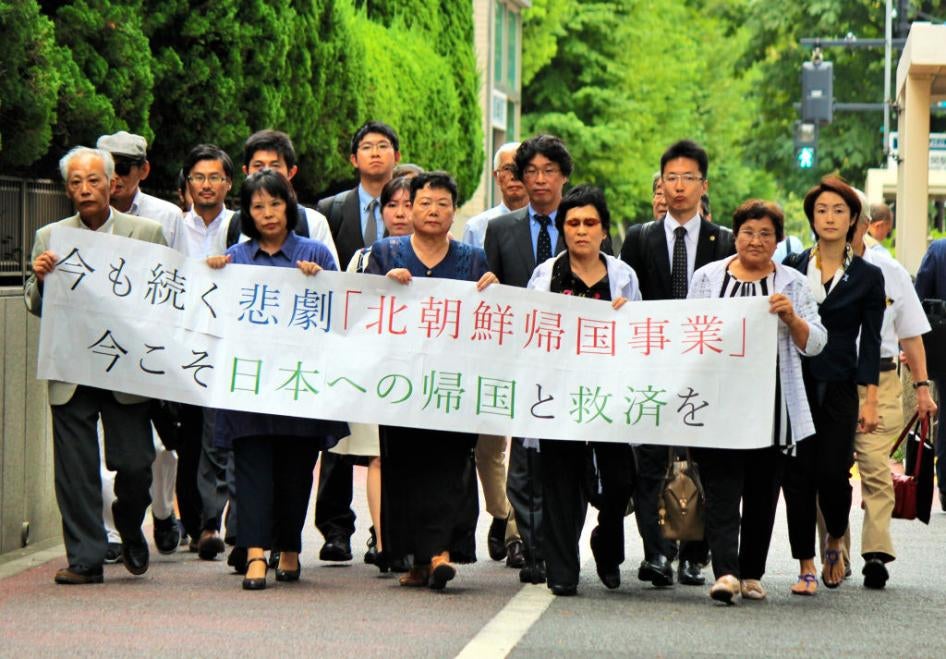 Escapees from North Korea and their supporters march to the Tokyo District Court to file a lawsuit against the North Korean government for violating their human rights, August 20, 2018. 