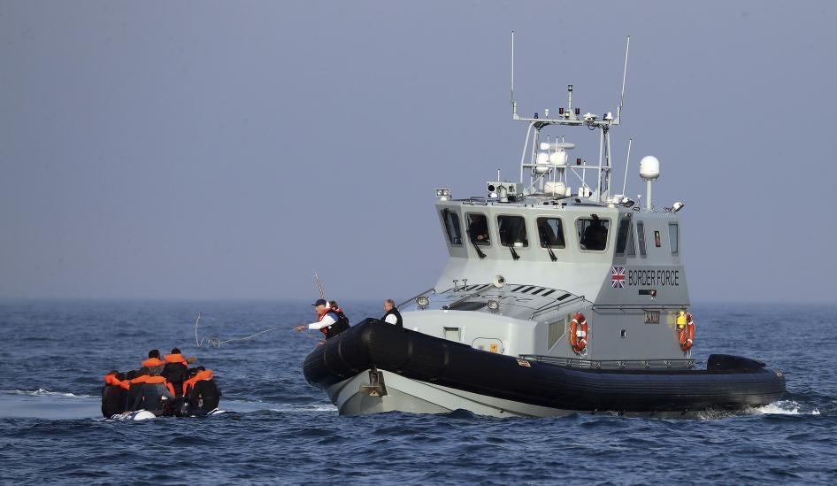 Border Force officers assist 20 Syrian migrants aboard HMC Hunter after they were stopped as they crossed The Channel in an inflatable dinghy headed in the direction of England.
