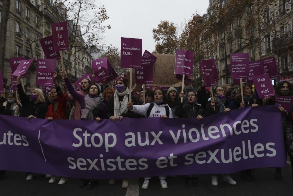 Women carry a banner reading "stop sexist and sexual violence " on November 20, 2021 in Paris.