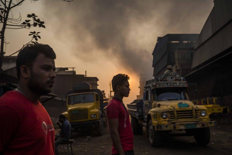 Two men stand in a smog-filled street