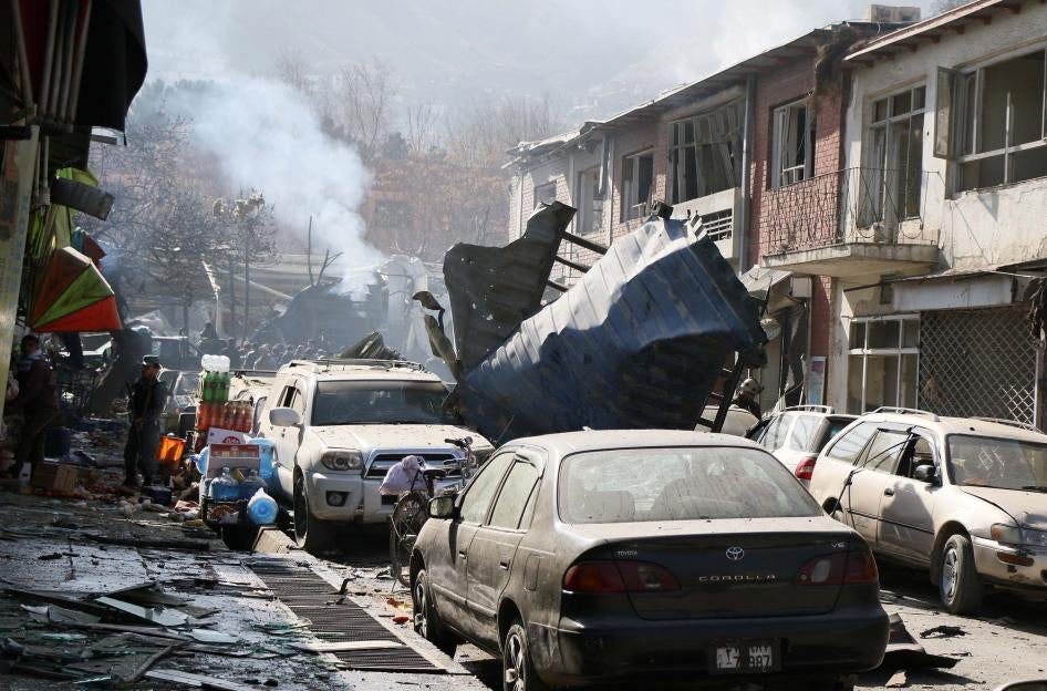 Afghan security officials inspect the site of a Taliban suicide bombing in Kabul.
