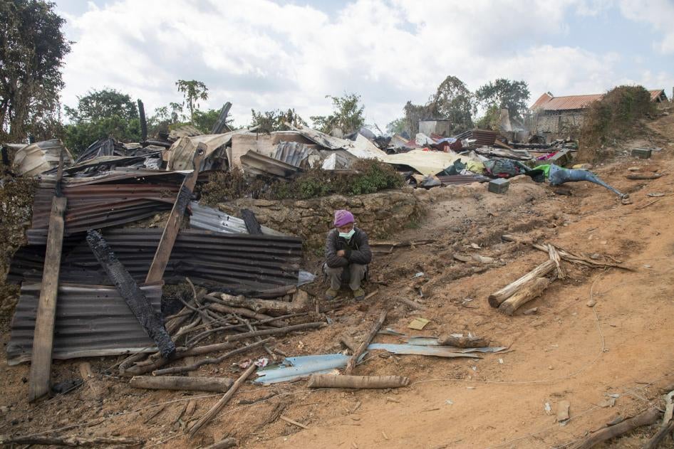 A man sits in front of a house in Shan State that was destroyed during fighting between Myanmar security forces and the Ta'ang National Liberation Army, January 10, 2023. 