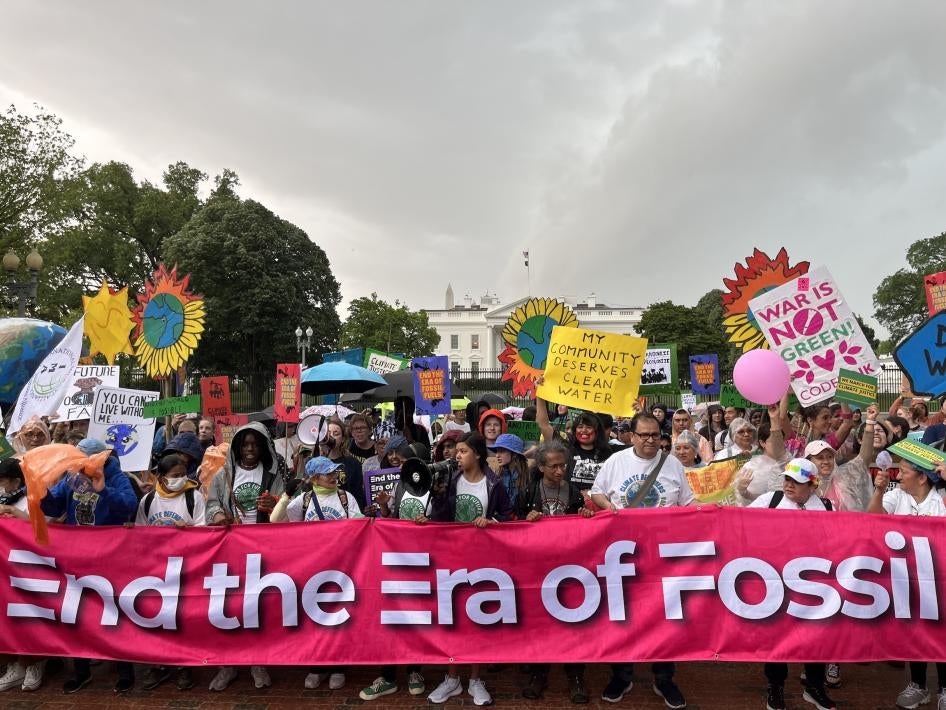 On Earth Day, marchers at the Whit House hold  a banner reading, “End the Era of Fossil Fuels” Washington, DC.