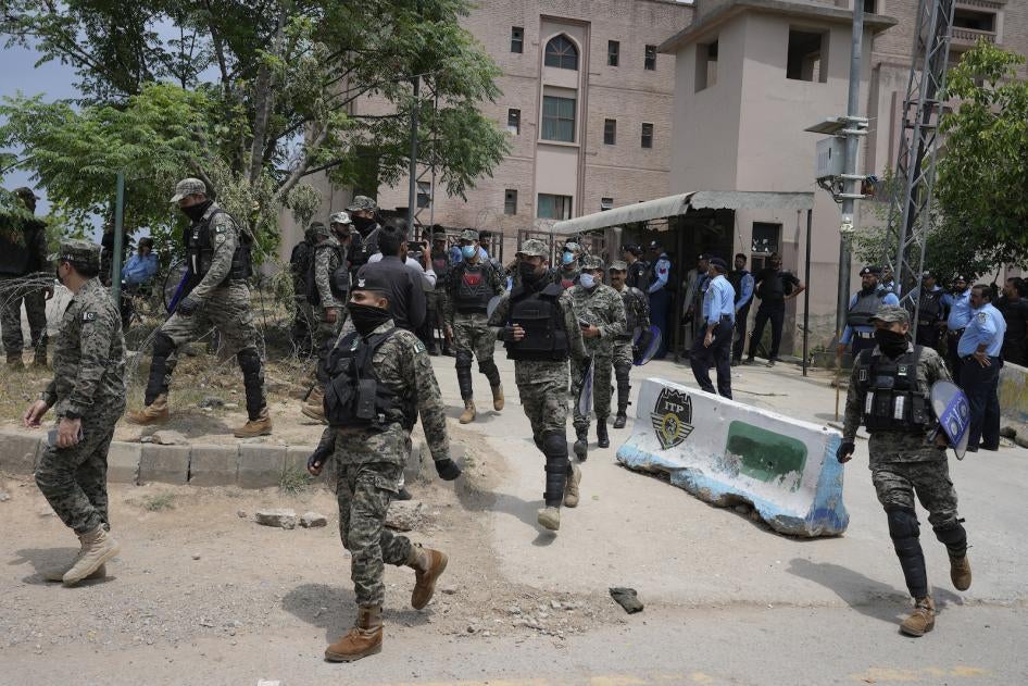 Paramilitary troops and police officers stand guard outside a court where Pakistan's former Prime Minister Imran Khan is scheduled to appear in Islamabad, Pakistan, May 23, 2023. 