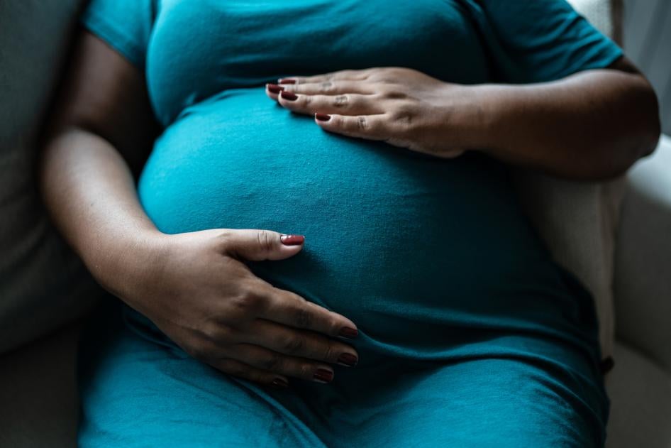  Pregnant woman touching her belly. 