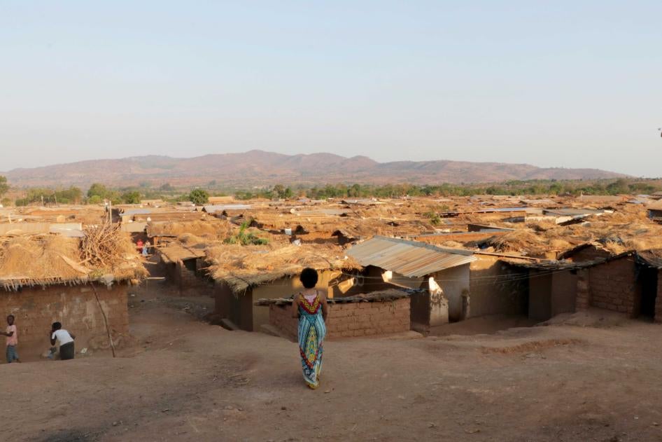 A woman watches children playing at Dzaleka Refugee Camp in Dowa, Malawi. 