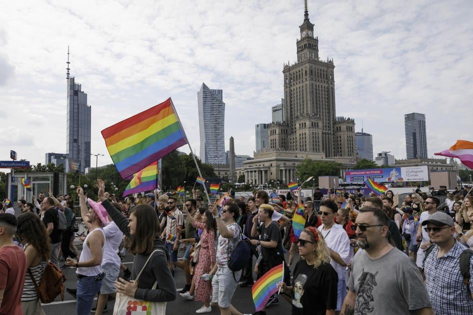 People march through the street with rainbow flags during the Warsaw's Equality Parade, Poland, June 17, 2023. 