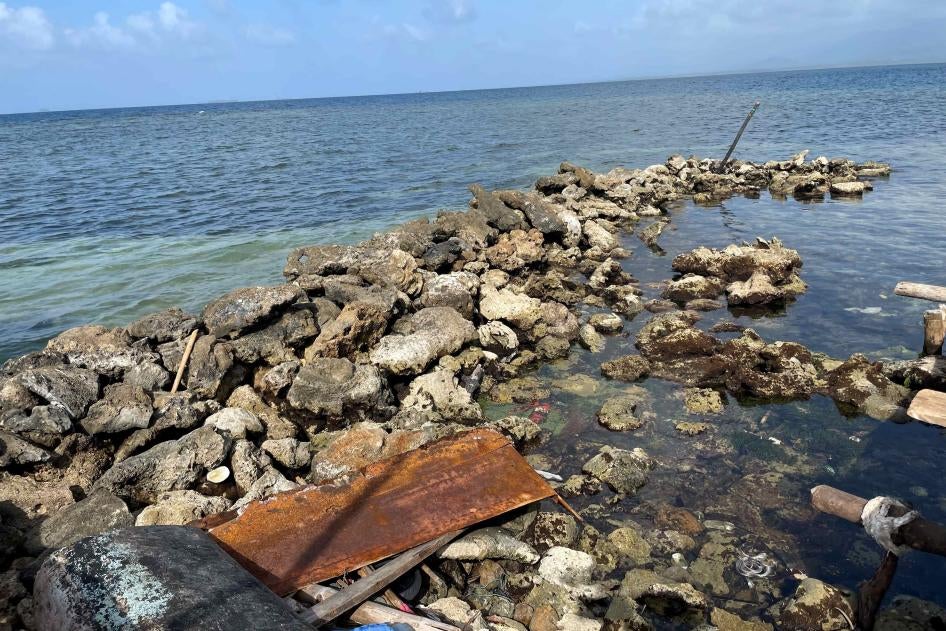 The practice of 'filling' with coral on a neighboring island.