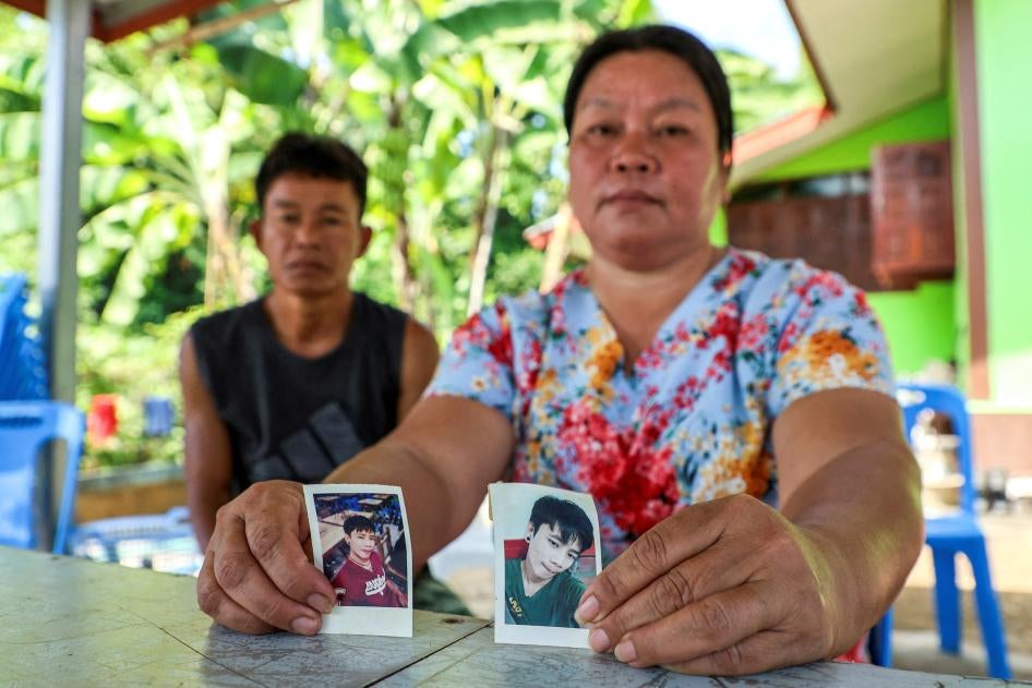 Thawatchai and Thongkoon On-kaew, parents of Natthaporn, hold photos of him outside their home in Nakhon Phanom, Thailand, October 10, 2023. Natthaporn was working in Israel when members of Palestinian armed groups took him hostage on October 7, 2023. 