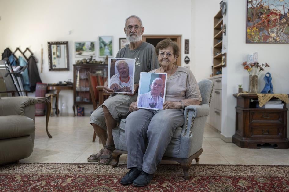Chanan and Edna Choen, hold up portraits of his sister, 77-year-old Margalit Moses, and her husband, 79-year-old Gadi Moses in their family home in Lakhish, Israel, October 30, 2023. The older Moses couple were abducted by Hamas-led fighters from their home in the kibbutz of Nir Oz on October 7, 2023. 