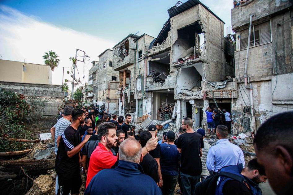 Palestinians inspect a damaged building