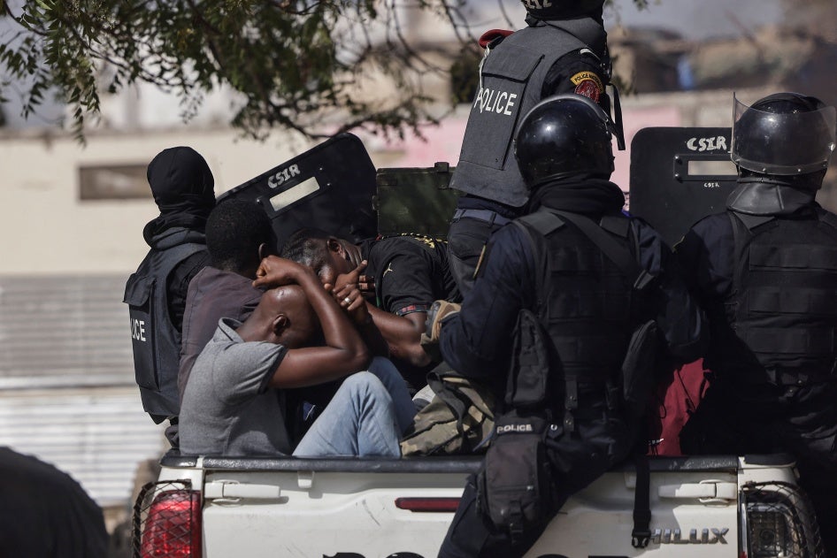 Detained demonstrators on a police pick up during a protest against the postponement of the February 25, 2024 presidential election, in Dakar, Senegal, on  February 9, 2024.