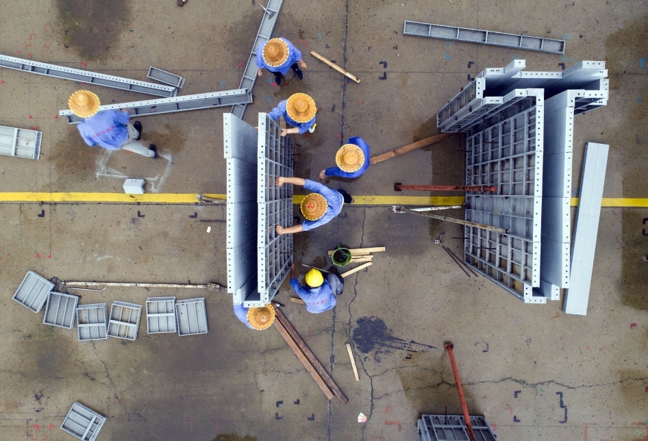 Workers make aluminum alloy products on a production line in Jinhu county, Jiangsu province, China, July 19, 2020.