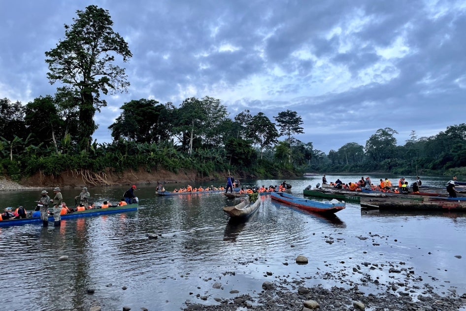 SENAFRONT officers coordinate the departure of “piraguas,” wooden canoes made from hollowed-out tree trunks