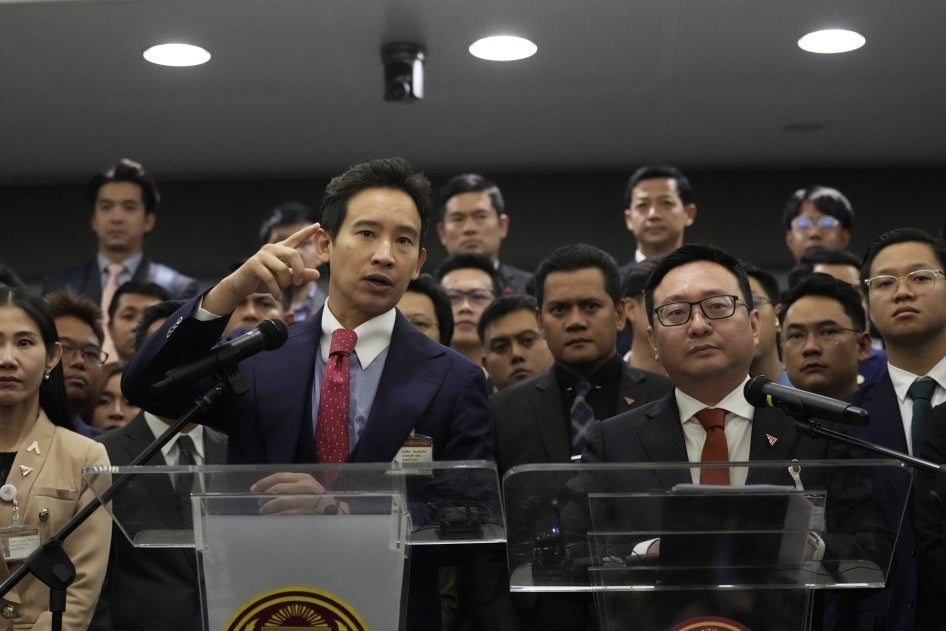 Former leader of the Move Forward Party Pita Limjaroenrat, left, and the party's current leader Chaithawat Tulathon speak at a news conference