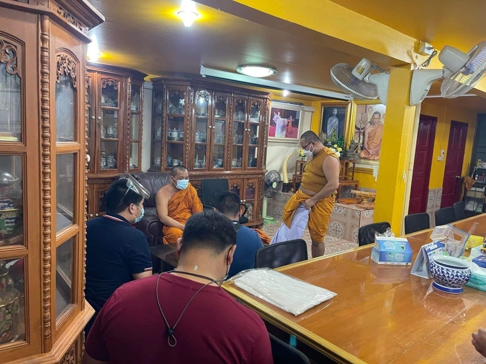 Thai authorities pressure Bor Bet to disrobe and put on civilian clothes as he is detained at a temple in Samut Prakan province, Thailand, December 2021. 