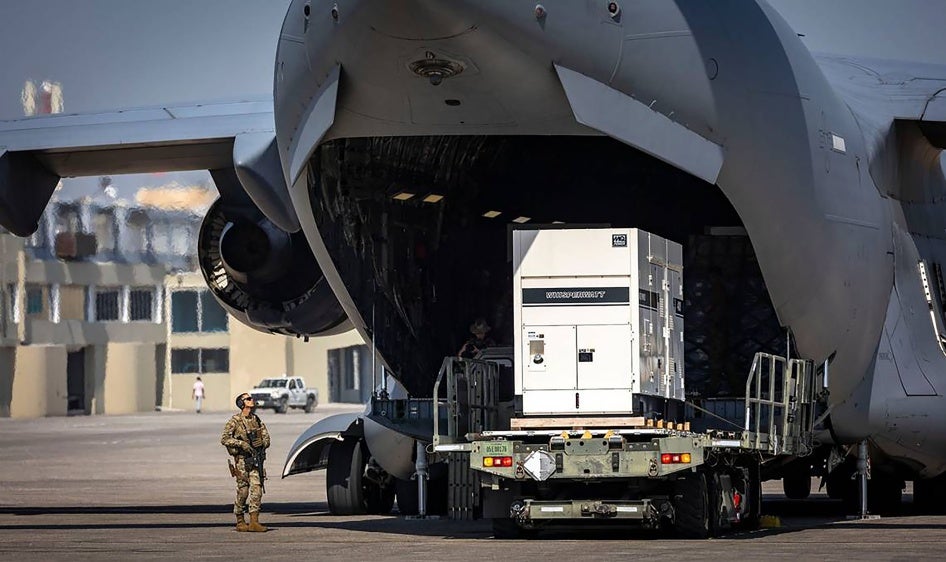 Supplies are offloaded from a U.S. Air Force C-17 cargo plane on the tarmac at Toussaint Louverture International Airport in Port-au-Prince, Haiti. The plane was carrying supplies for the camp being built for Kenyan police officers who will lead a Multinational Security Support mission into Haiti, May 15, 2024. 