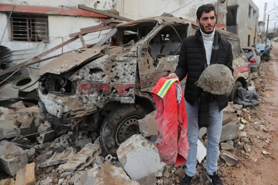 A man carries belongings of a paramedic killed at a paramedic center hit on March 27, 2024, by an Israeli airstrike in Habbarieh, southern Lebanon, March 27, 2024. 