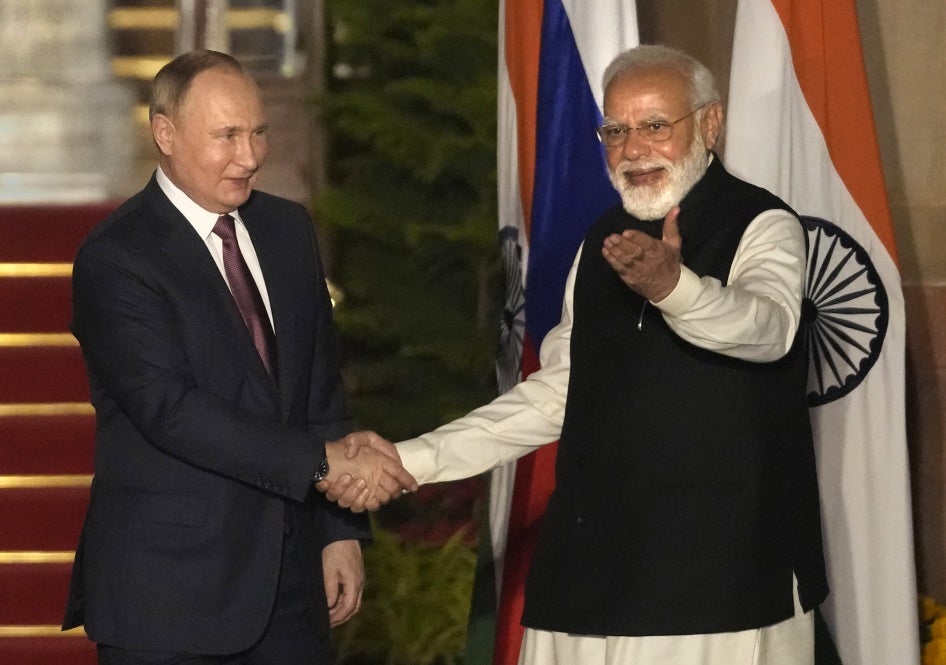 Russian President Vladimir Putin and Indian Prime Minister Narendra Modi greet each other before their meeting in New Delhi, India, December 6, 2021.