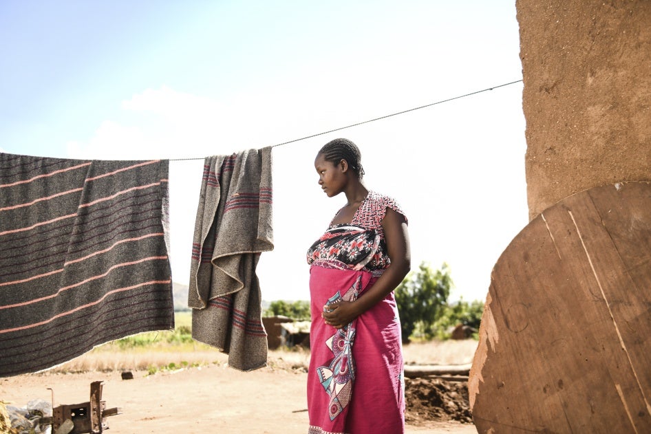 A pregnant woman waits to see a traditional birth attendant at her home in Simika Village, Chiradzulu, southern Malawi, 2021.