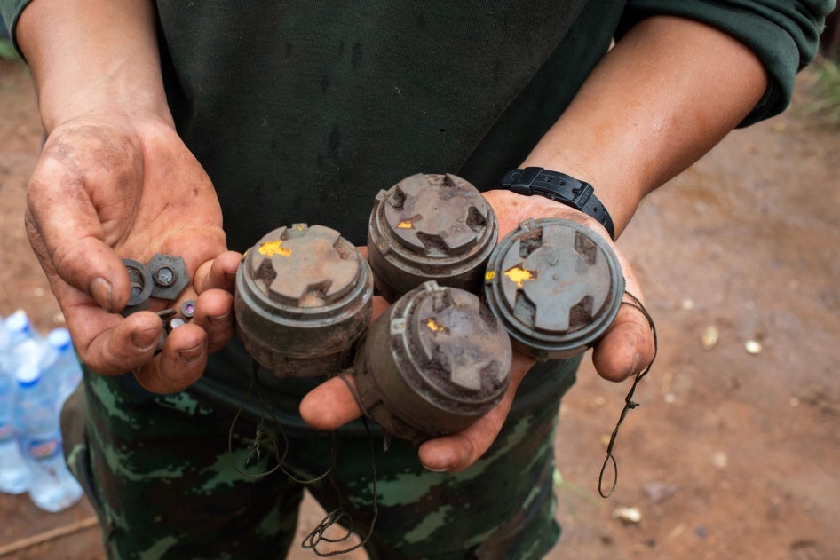 A member of the opposition Karenni Nationalities Defence Force holds antipersonnel mines planted by the Myanmar military and removed during demining operations near Pekon township, July 11, 2023.