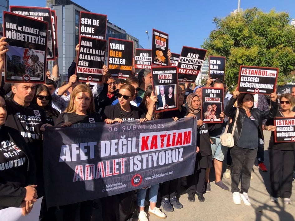 At an October 7, 2024 protest organized by the Families in Pursuit of Justice Platform, founded by those who lost their loved ones in the February 6, 2023 earthquakes, members hold a banner that reads, “Not a disaster but a massacre. We demand justice.”