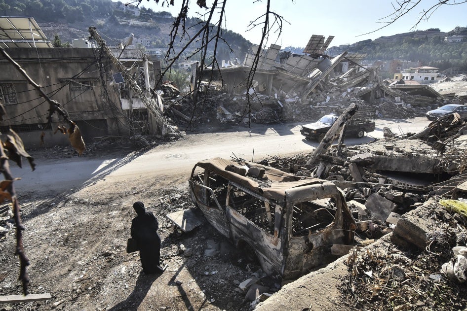A returning resident to Nabatieh, in southern Lebanon, stands before the wreckage in the city on November 30, 2024, days after the start of a ceasefire between Israel and Hezbollah. 