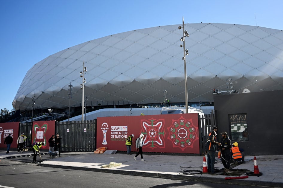 Des ouvriers devant le stade Al-Medina à Rabat, le 18 décembre 2025, à l'approche de la Coupe d'Afrique des nations (CAN).