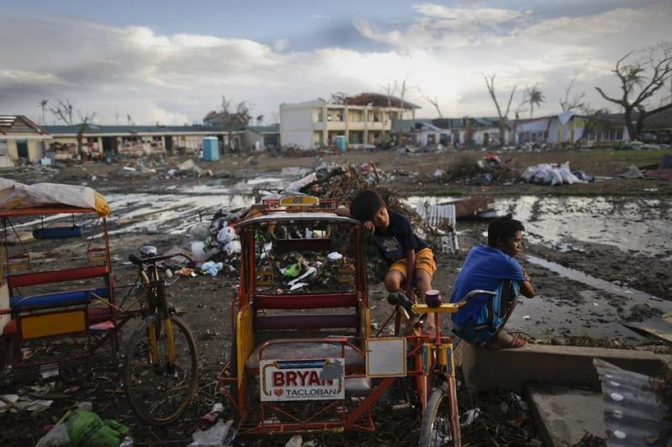 Survivors of Typhoon Haiyan pass the time at a school where hundreds have found shelter at, in Tacloban, Philippines, November 21, 2013.