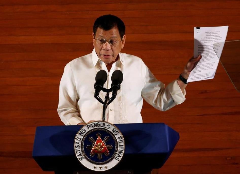 Philippine President Rodrigo Duterte holds up a copy of his speech as he speaks before the lawmakers during his first State of the Nation Address at the Philippine Congress in Quezon city, Metro Manila, Philippines July 25, 2016.