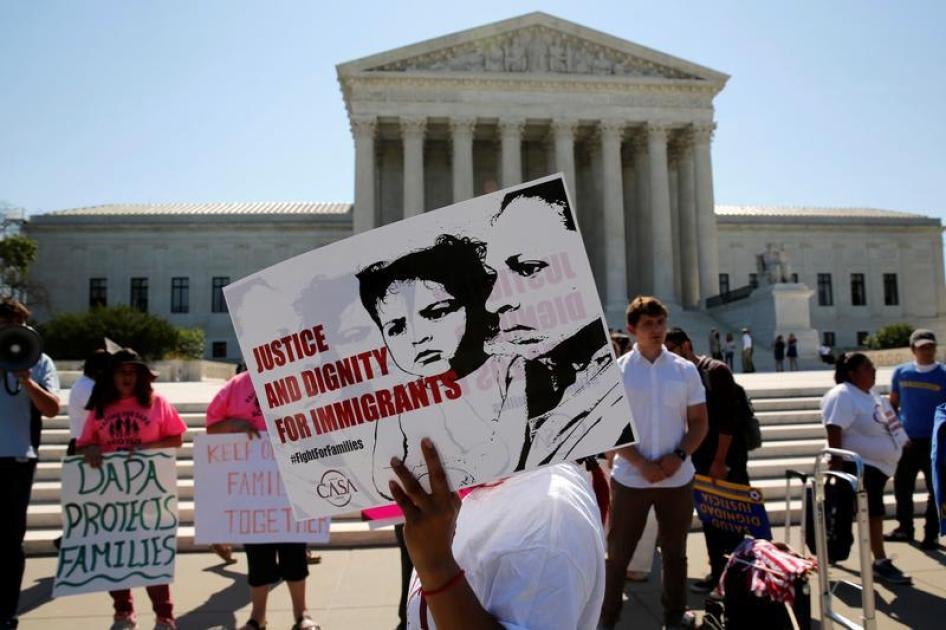 Demonstrators from the immigrant community advocacy group CASA carry signs as they march in the hopes of a ruling in their favor on decisions at the Supreme Court building in Washington, U.S. June 20, 2016.