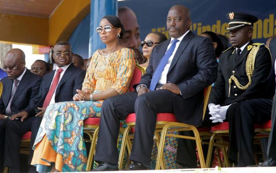 Kalev Mutond, Director of the National Intelligence Agency (ANR) in the Democratic Republic of Congo, sits to the right of First Lady Marie Olive Lembe and President Joseph Kabila during the country’s independence anniversary celebration in Kindu, capital