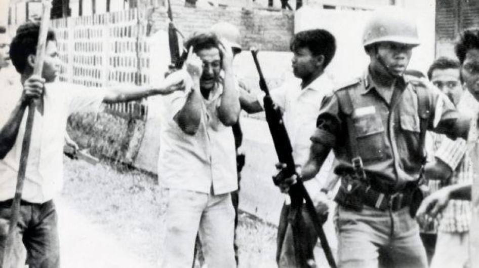 A student is led away after a raid on a university in Jakarta, Indonesia in 1965.