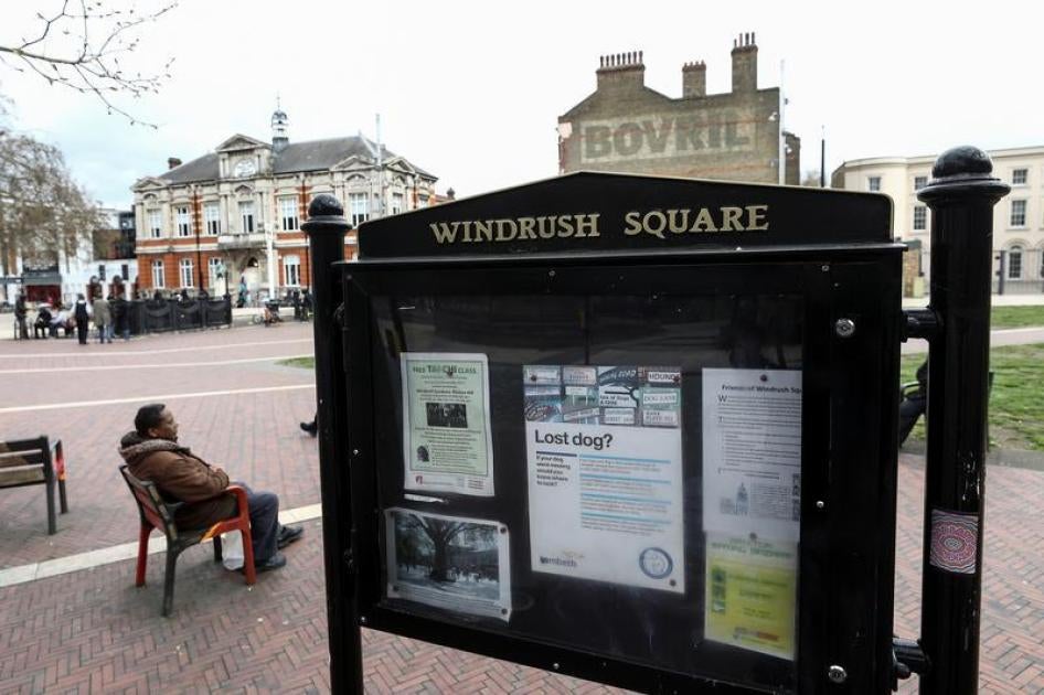 A man sits on a bench next to a sign on Windrush Square in the Brixton district of London, Britain April 16, 2018.