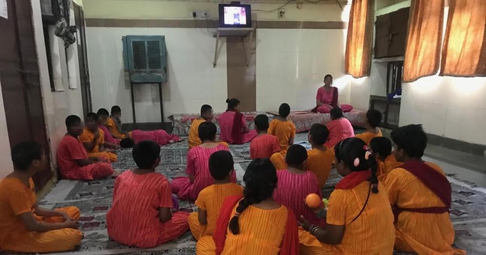Girls watch television inside the girls’ wing at Asha Kiran, a government-run residential institution for people with intellectual disabilities and mental health needs in Delhi, in April 2018.