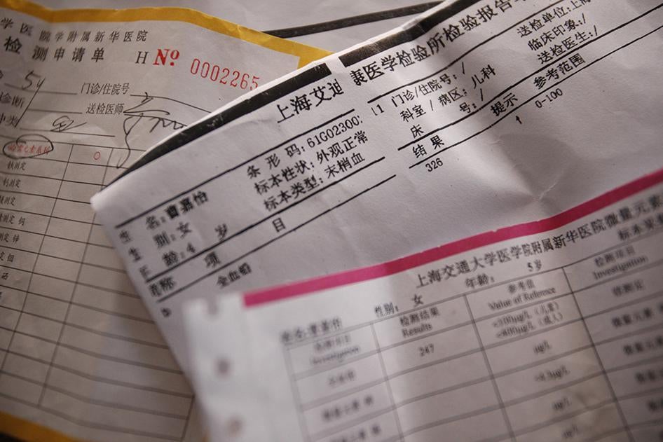 中国上海康花新村居民的血铅检测报告单，摄於2011年9月15日。上海城郊工业区里有许多这样的村落，村民指出，附近工厂和垃圾场导致家中孩童血铅超标。铅中毒的污染源一时难以查明，但该村南边有工业区，四周有玉米田、菜园和老旧农舍，多家化工、电池和电子工厂均近在咫尺。