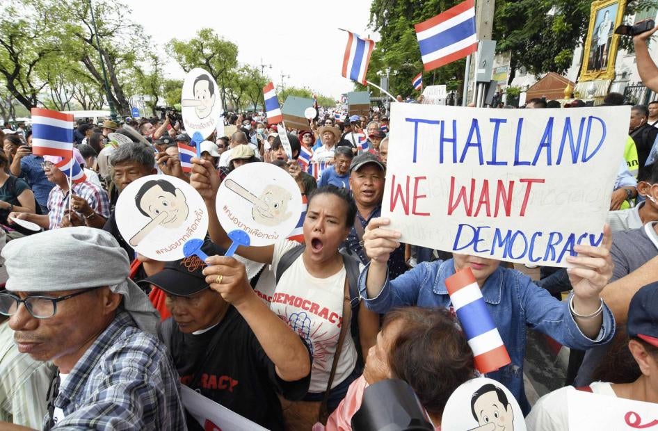 Protesters march near Thammasat University in Bangkok on May 22, 2018, the fourth anniversary of the Thai junta's 2014 coup, demanding that a general election be held this year. (