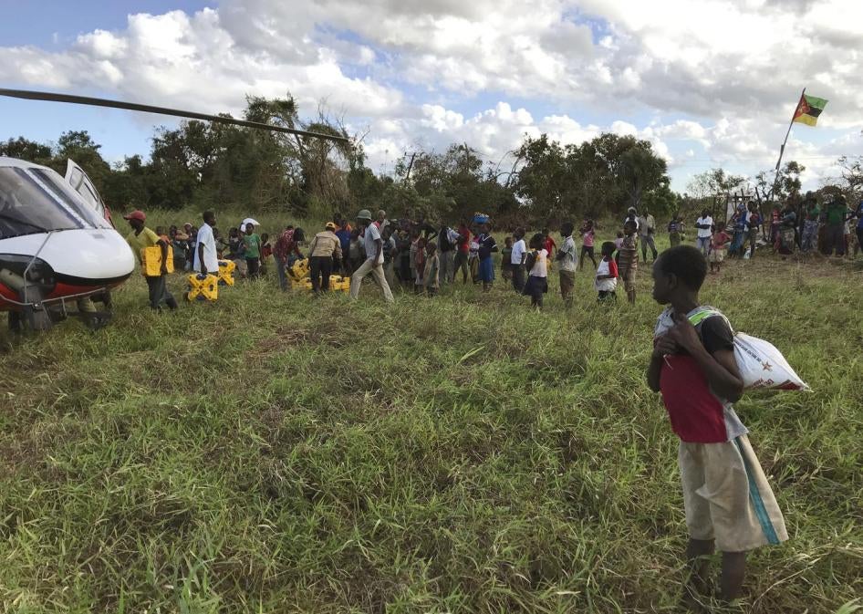 A boy watches the distribution of aid in the remote village of Bopira, Mozambique, April 6, 2019. © 2019 AP Photo/Cara Anna)