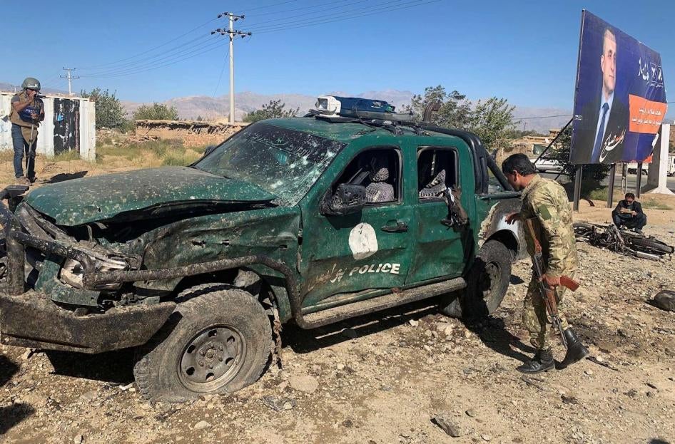 Afghan police inspect the site of a suicide attack in Parwan, Afghanistan, September 17, 2019. 