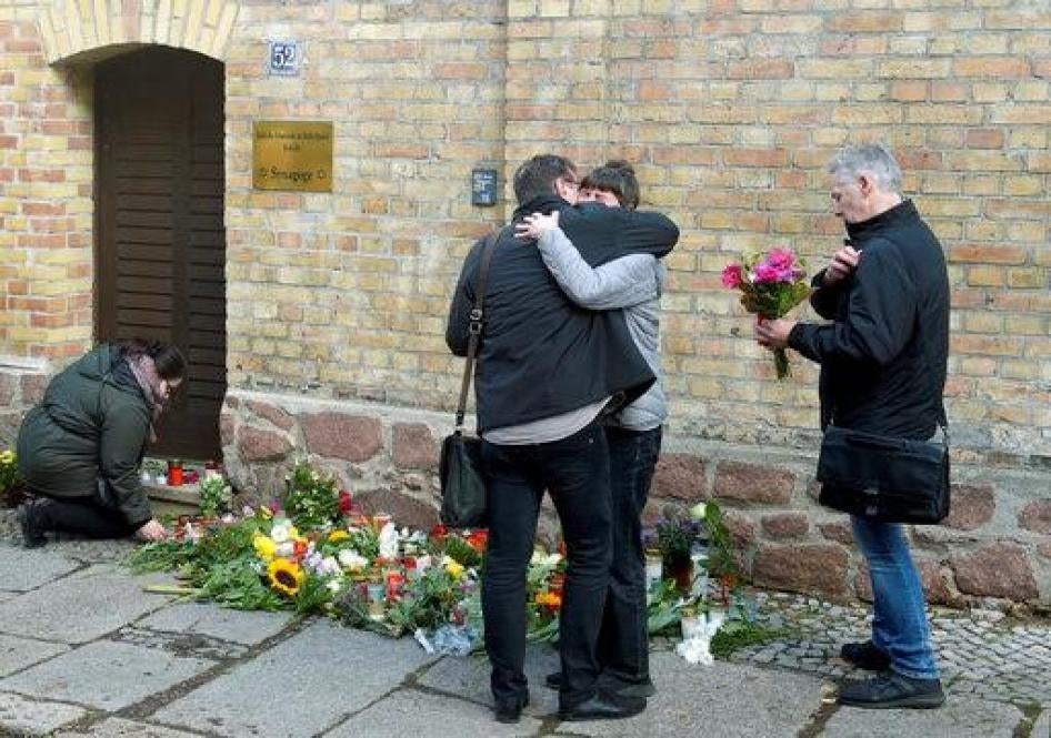 People mourn in front of a synagogue in Halle, Germany, Thursday, Oct. 10, 2019. 