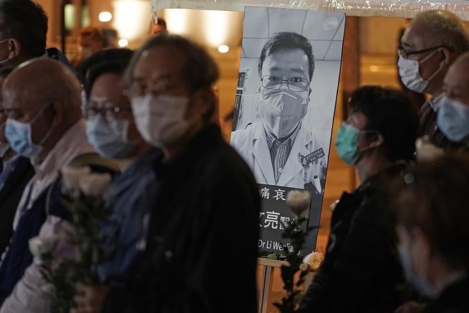 People wearing masks, attend a vigil for Chinese doctor Li Wenliang, in Hong Kong, February 7, 2020.