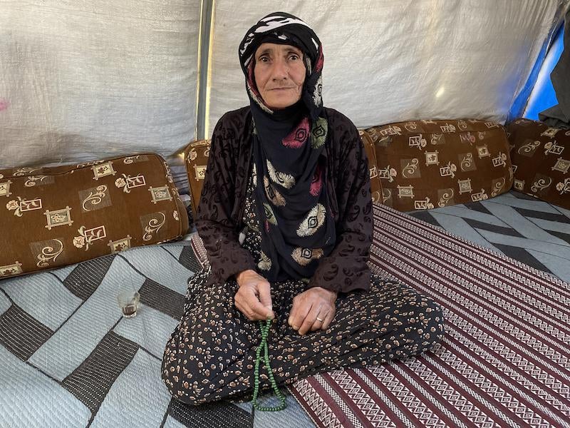 When Maryam, 68, fled her hometown in Turkish-occupied northern Syria in March 2023, she walked for three days along the Khabur River until she reached al-Hasakeh city, where she was finally reunited with family members at Washokani Camp for internally displaced Syrians, al-Hasakeh governorate, Syria, May 2023. 