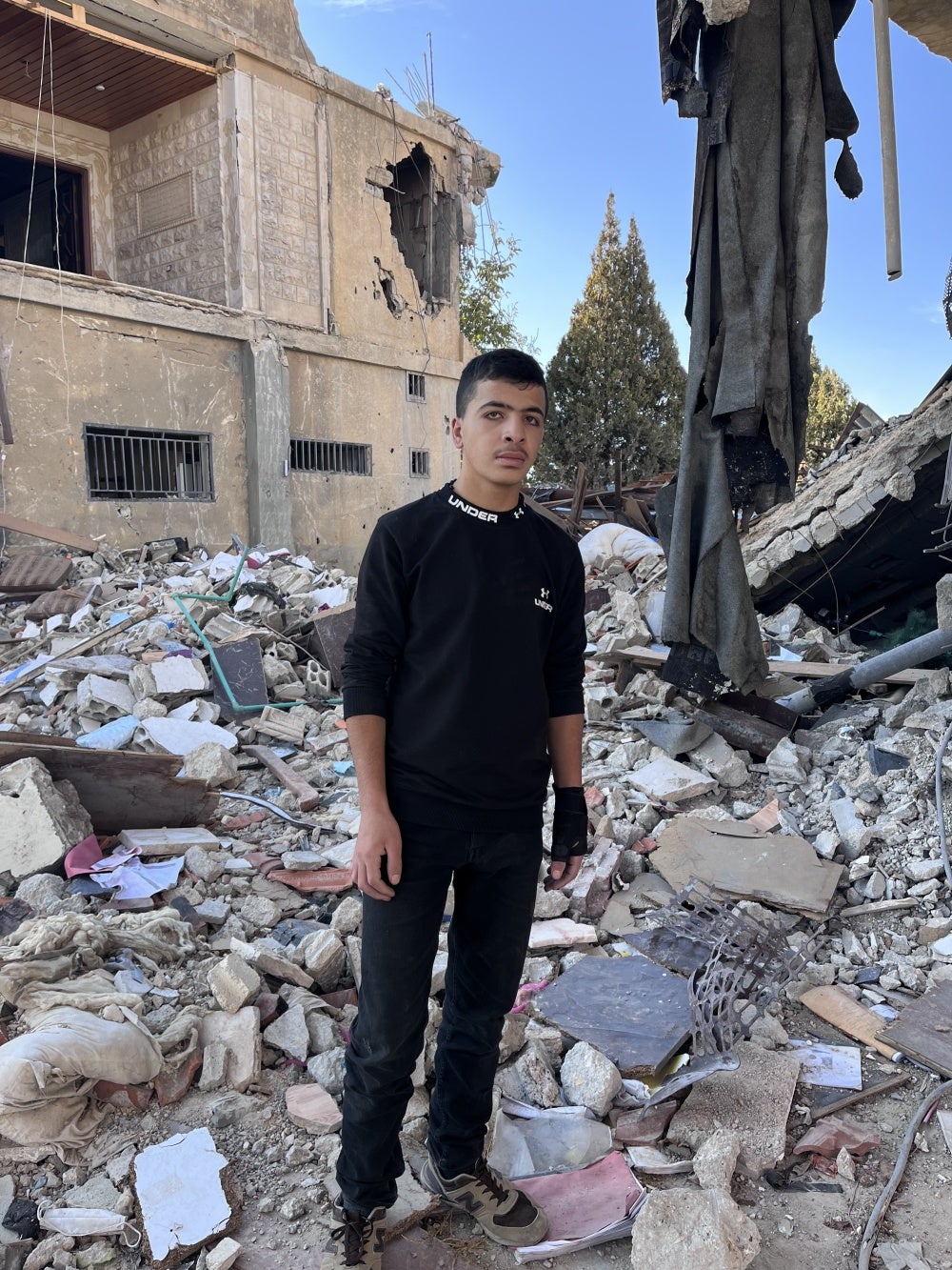 Youssef standing in what is left of a residential building after an Israeli airstrike on September 25, 2024, Younine, Lebanon. 