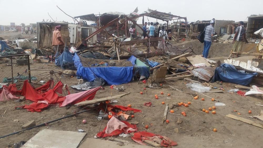 Mastaba residents clean up the market the day after the March 15 airstrike. 