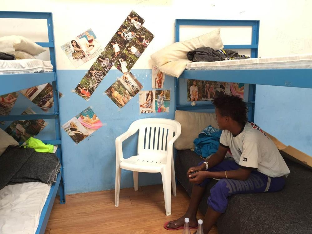 An Eritrean child traveling alone at the Pozzallo “hotspot” in Sicily, Italy. Some children at the center had been there for two weeks, unable to call home due to a broken telephone.