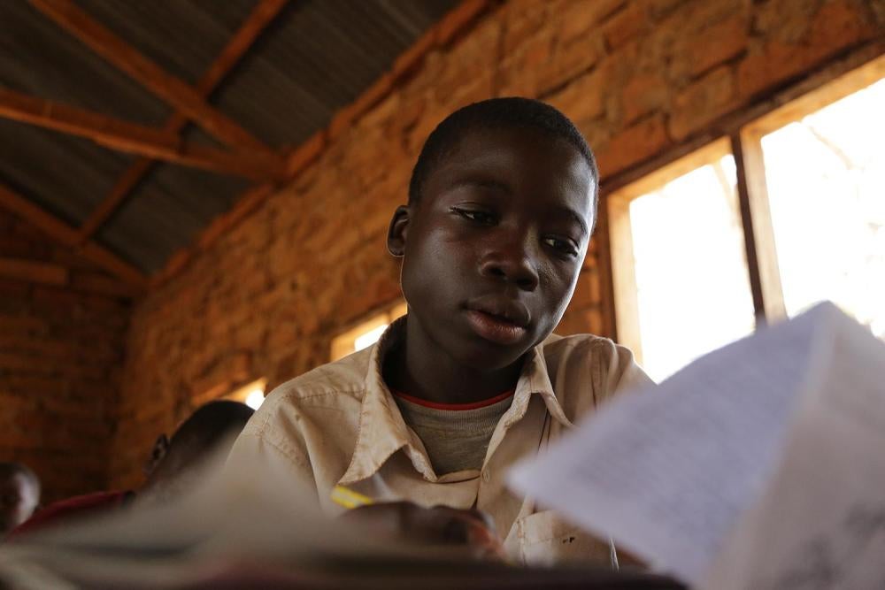 A 13-year-old boy, who mines gold, attends classes in a small-scale mining area in Mbeya Region. Work in mining impacts children’s performance and attendance at school. © 2013 Justin Purefoy for Human Rights Watch