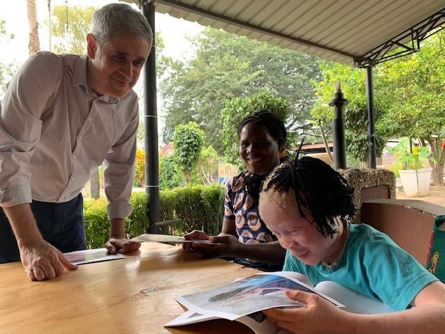 Josina reads Human Rights Watch's report, "From Cradle to Grave," in Mozambique.