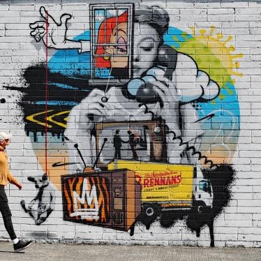A man walks past a street art mural by the artist ADW in County Laois, Ireland, May 30, 2020. Entitled "Is it Still raining? I hadn't noticed", the work deals with the issue of mental health during the Covid-19 lockdown.