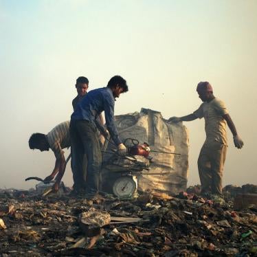Migrant workers weigh scrap metal, Thilafushi, Maldives.
