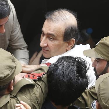 Pakistani police escort Mir Shakilur Rehman to court following his arrest in Lahore, Pakistan, March 13, 2020.